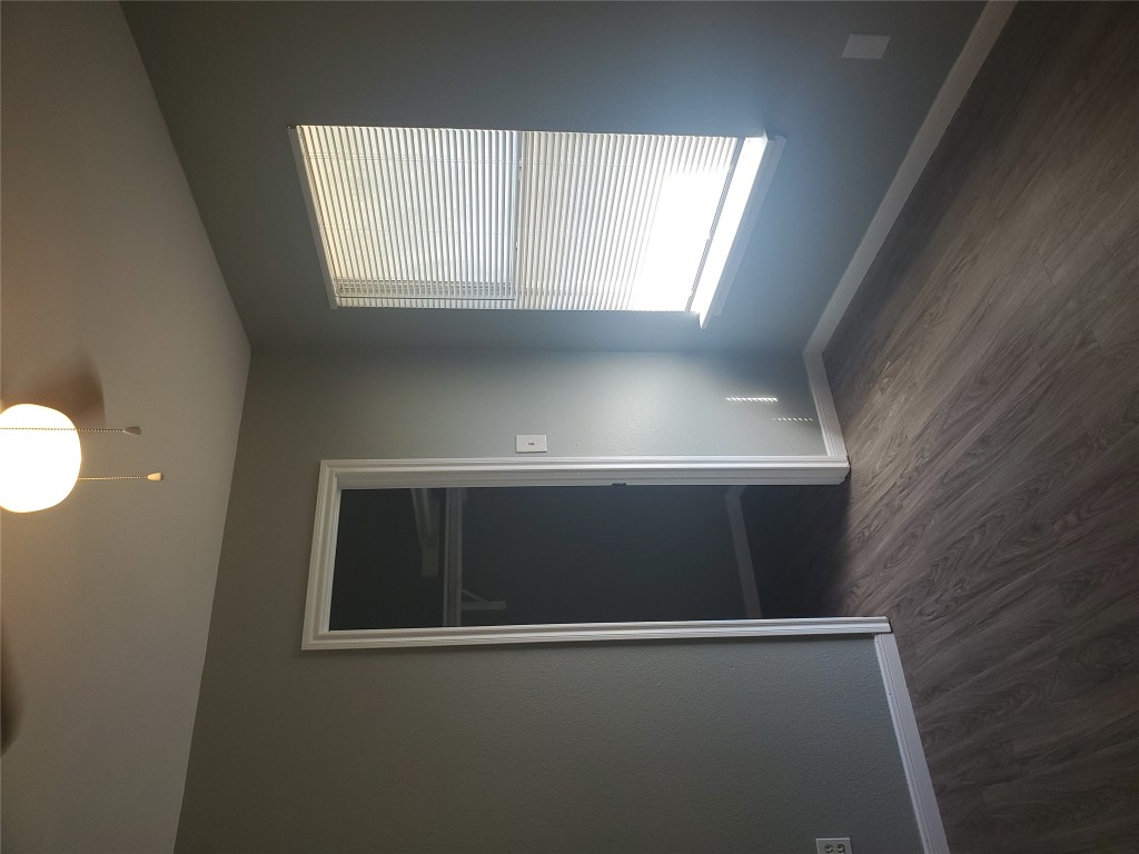 2221 Creekside Lane, Unit B Georgetown, TX 78626 - Photo 20 of 33 Unfurnished bedroom featuring dark wood-style flooring, a spacious closet, and a ceiling fan