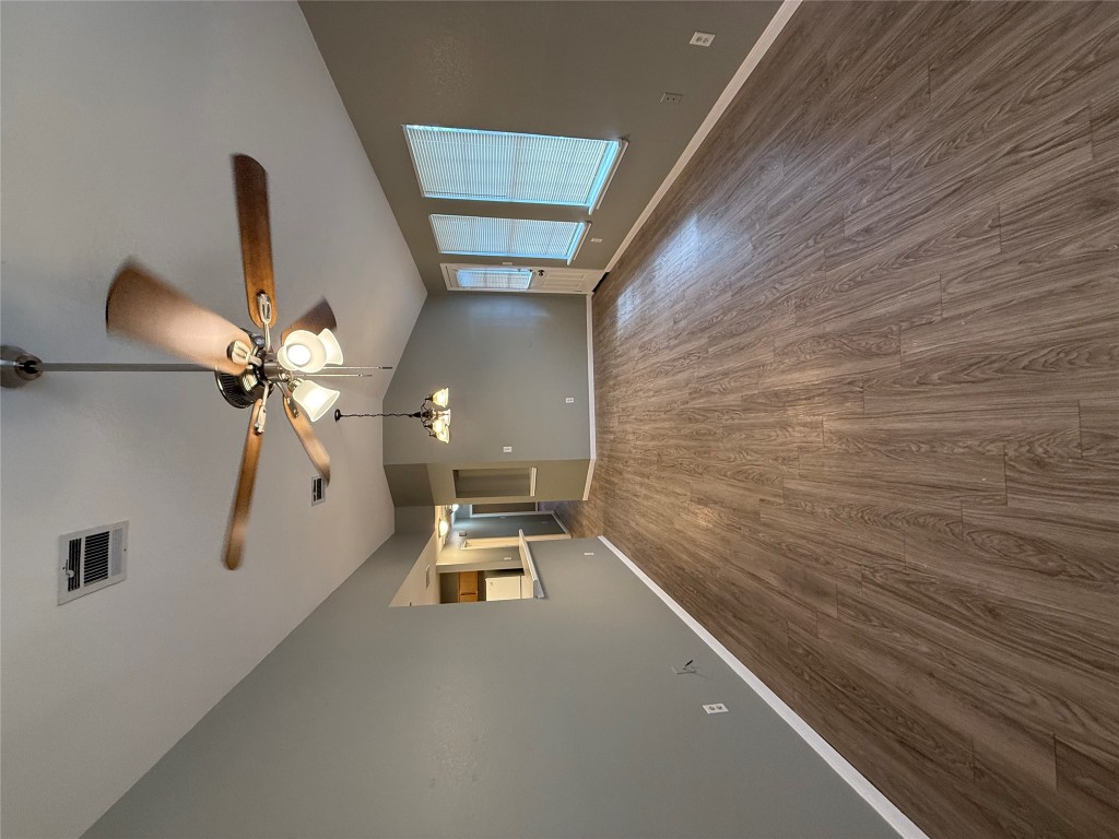 2221 Creekside Lane, Unit B Georgetown, TX 78626 - Photo 3 of 33 Unfurnished living room with vaulted ceiling, dark wood-style flooring, and ceiling fan