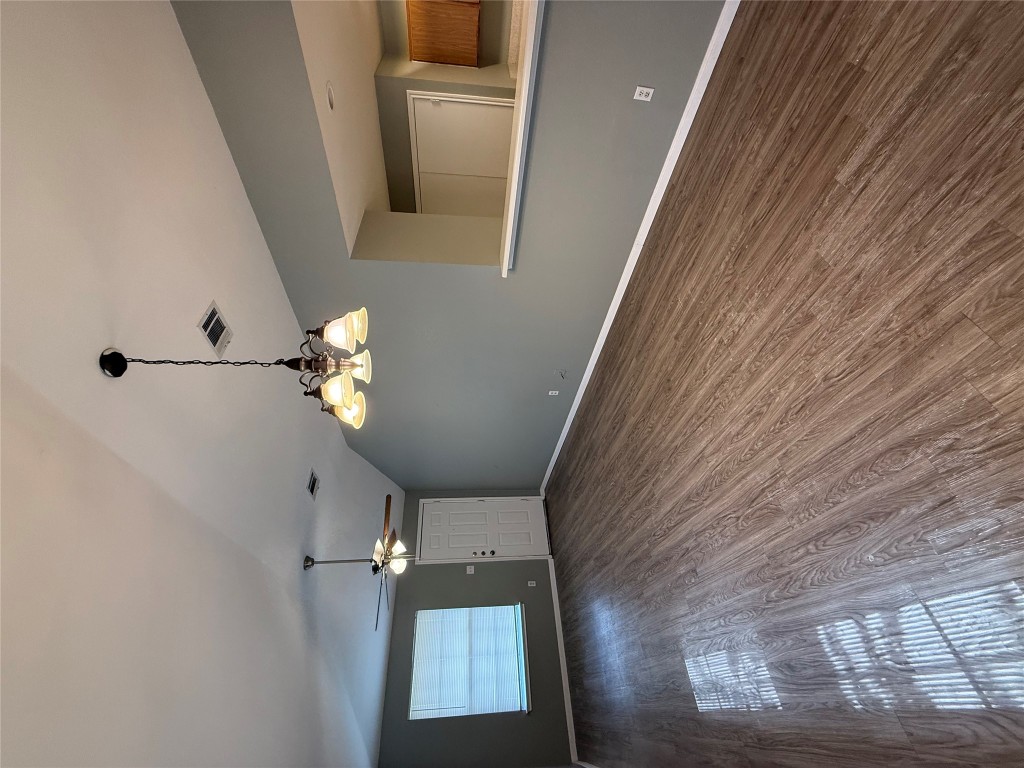 2221 Creekside Lane, Unit B Georgetown, TX 78626 - Photo 4 of 33 Unfurnished living room with dark wood-style flooring, a chandelier, lofted ceiling, and a ceiling fan