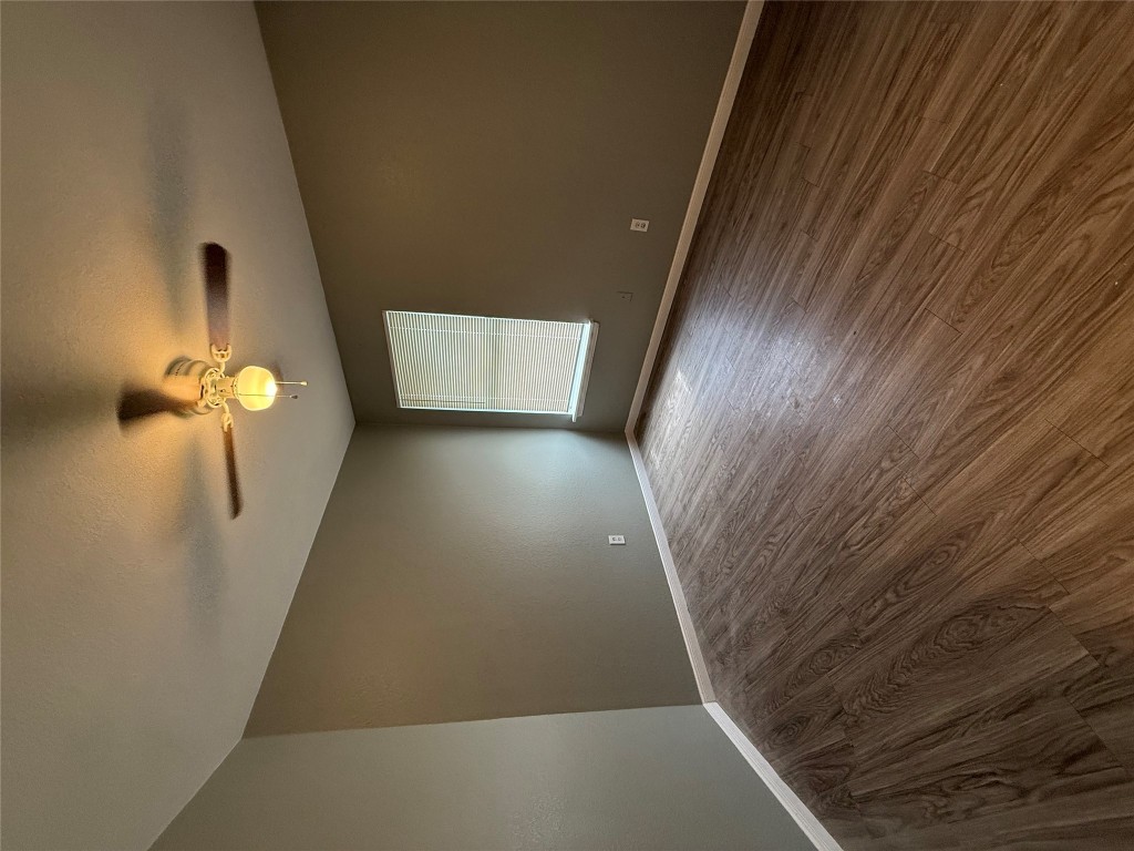 2221 Creekside Lane, Unit B Georgetown, TX 78626 - Photo 7 of 33 Empty room featuring wood finished floors, a textured ceiling, and ceiling fan
