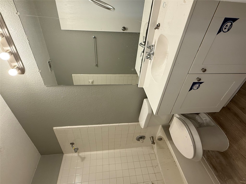 2221 Creekside Lane, Unit B Georgetown, TX 78626 - Photo 9 of 33 Bathroom with a textured wall, shower / washtub combination, dark wood finished floors, vanity, and a textured ceiling