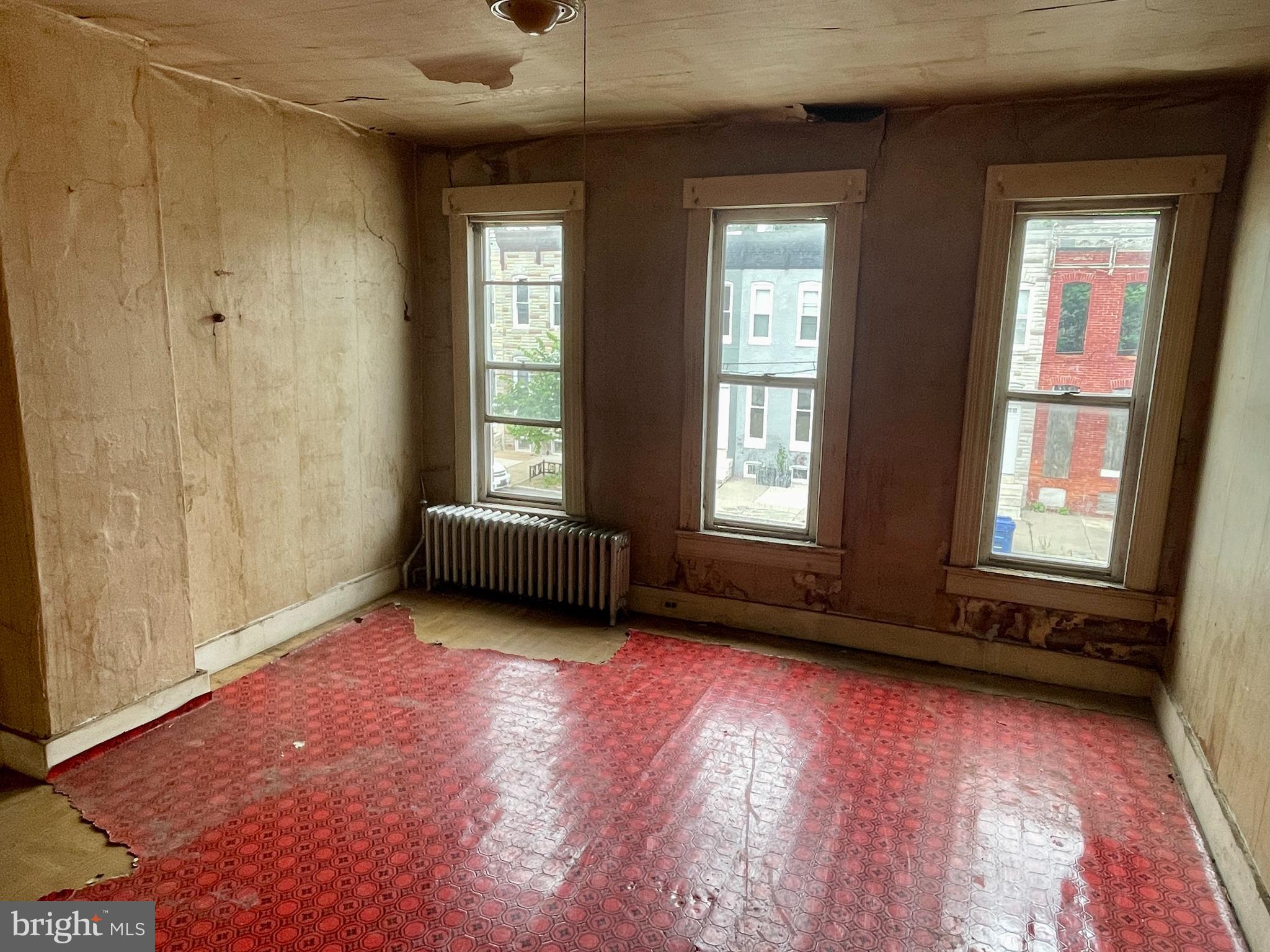 1626 North Wolfe Street Baltimore, MD 21213 - Photo 10 of 20 a view of an empty room with a window and wooden floor