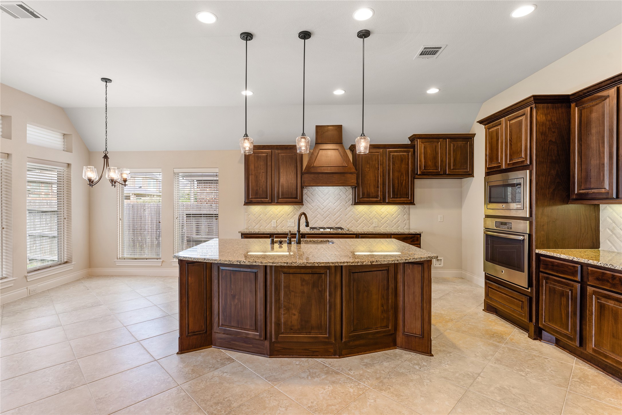 2938 Bobby Jones Road Katy, TX 77494 - Photo 10 of 28 a kitchen with kitchen island a counter top space appliances and a ceiling fan