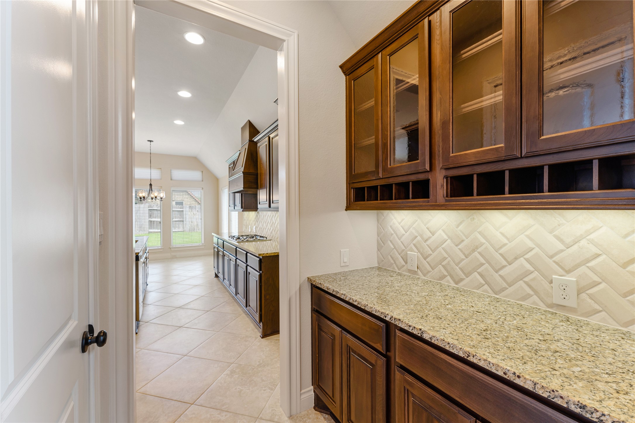 2938 Bobby Jones Road Katy, TX 77494 - Photo 12 of 28 a view of a kitchen with a sink and dishwasher a oven with wooden cabinets