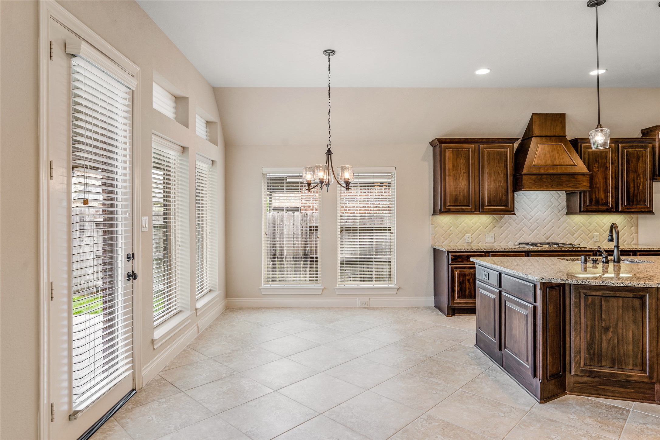 2938 Bobby Jones Road Katy, TX 77494 - Photo 13 of 28 a kitchen with stainless steel appliances granite countertop a stove a sink and a refrigerator