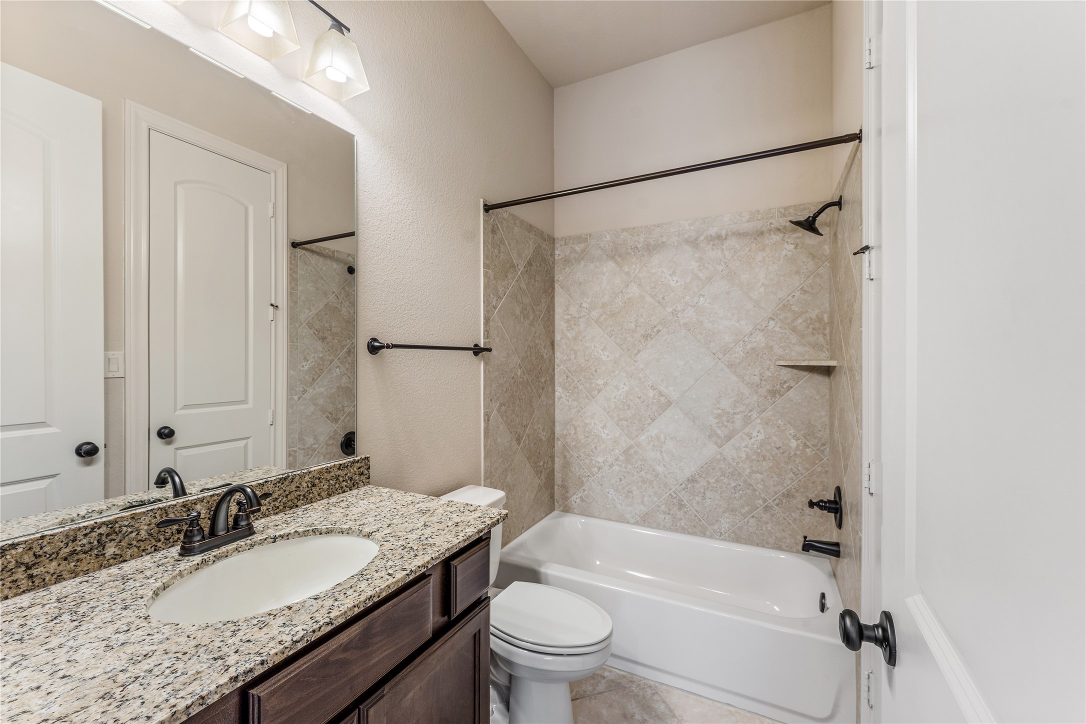 2938 Bobby Jones Road Katy, TX 77494 - Photo 19 of 28 a bathroom with a granite countertop sink toilet mirror and shower