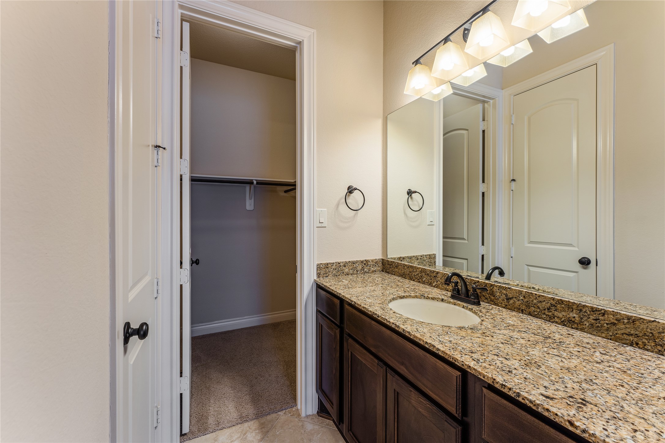 2938 Bobby Jones Road Katy, TX 77494 - Photo 21 of 28 a bathroom with a granite countertop sink and a mirror