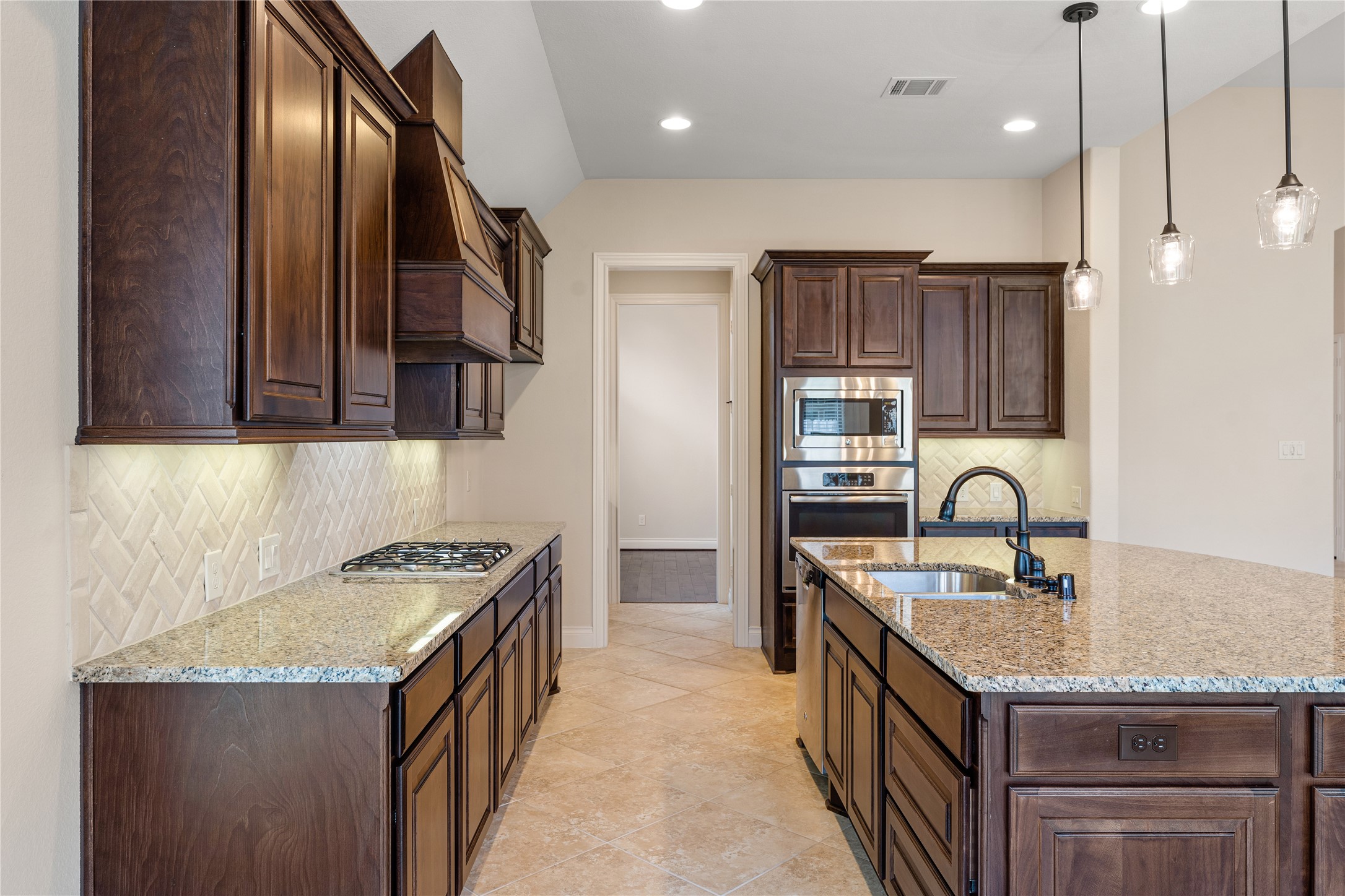 2938 Bobby Jones Road Katy, TX 77494 - Photo 9 of 28 a kitchen with granite countertop stainless steel appliances a sink stove and cabinets