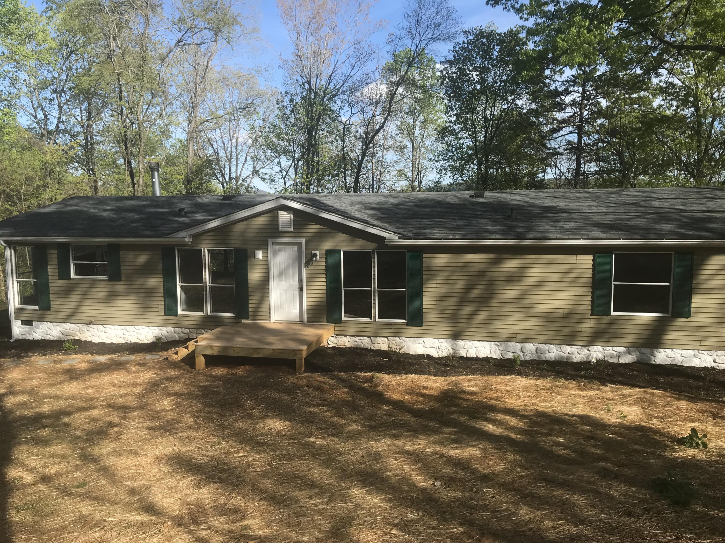 100 Lookout Ridge Road Blue Ridge, VA 24064 - Photo 1 of 11 a front view of a house with a garden