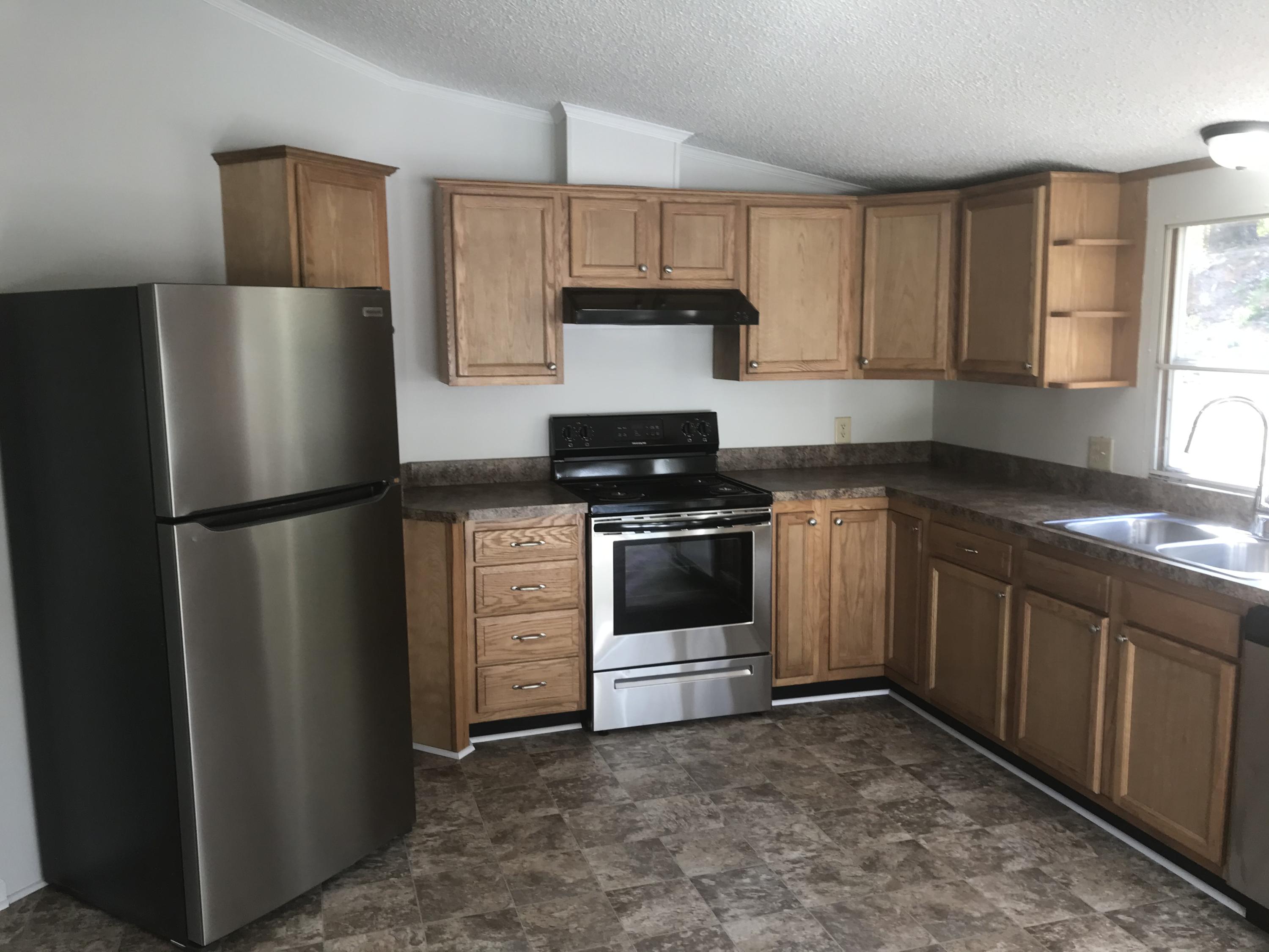 100 Lookout Ridge Road Blue Ridge, VA 24064 - Photo 6 of 11 a kitchen with a refrigerator stove and sink
