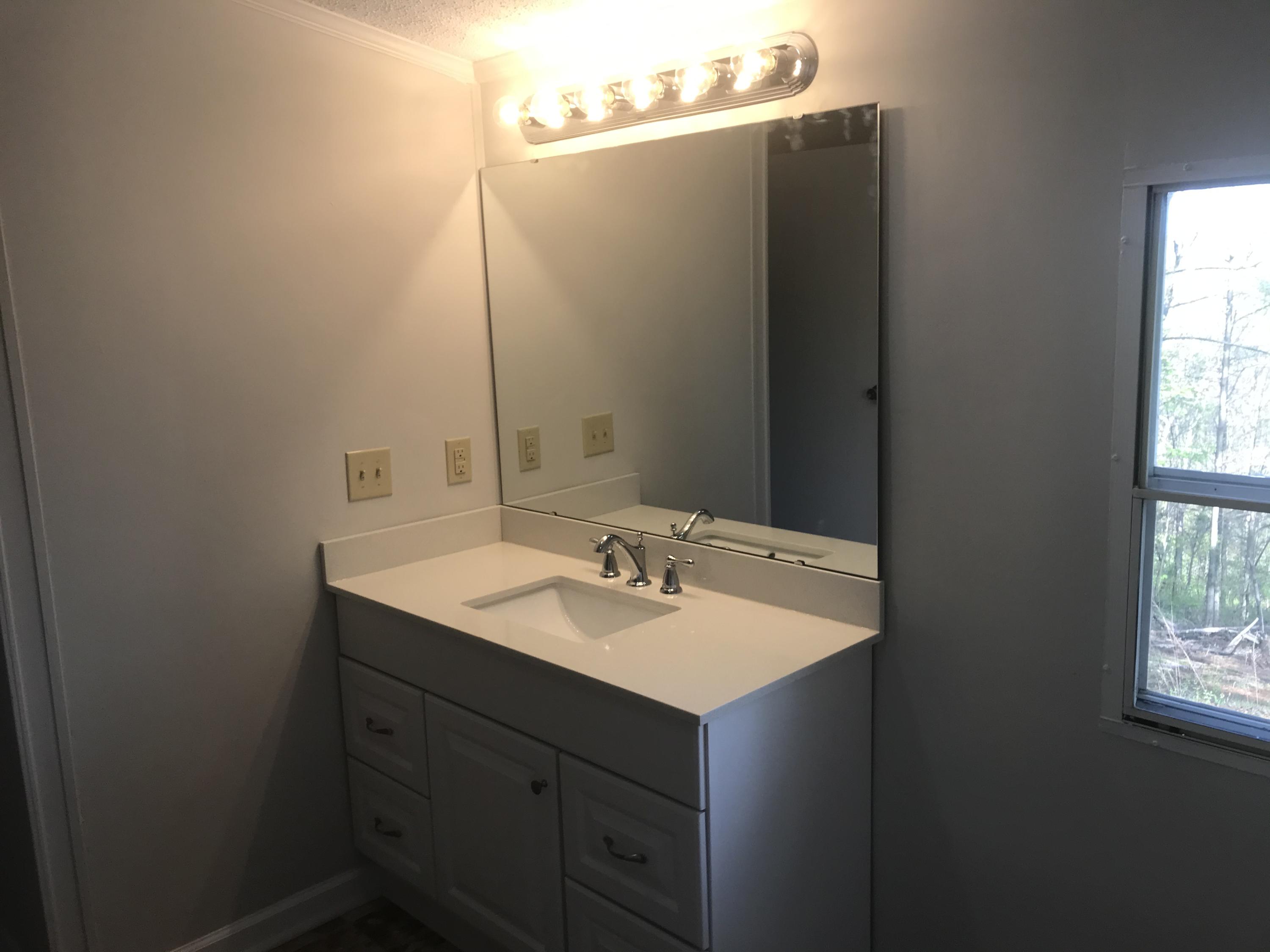 100 Lookout Ridge Road Blue Ridge, VA 24064 - Photo 8 of 11 a bathroom with a sink and a mirror
