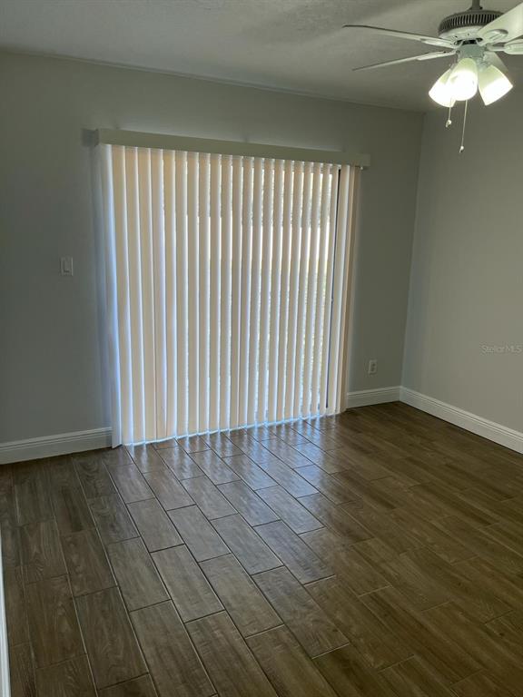 1373 Via Villanova Way Winter Springs, FL 32708 - Photo 8 of 11 a view of an empty room with wooden floor and a window