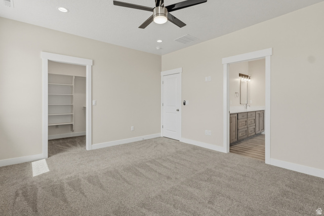 169 West 100 South Joseph, UT 84739 - Photo 14 of 35 Unfurnished bedroom with light carpet, a spacious closet, recessed lighting, ensuite bathroom, and a ceiling fan
