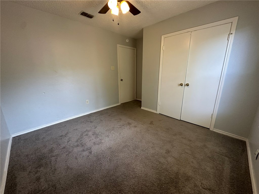 2189 Spring Park Drive Ingleside, TX 78362 - Photo 27 of 35 an empty room with a chandelier fan