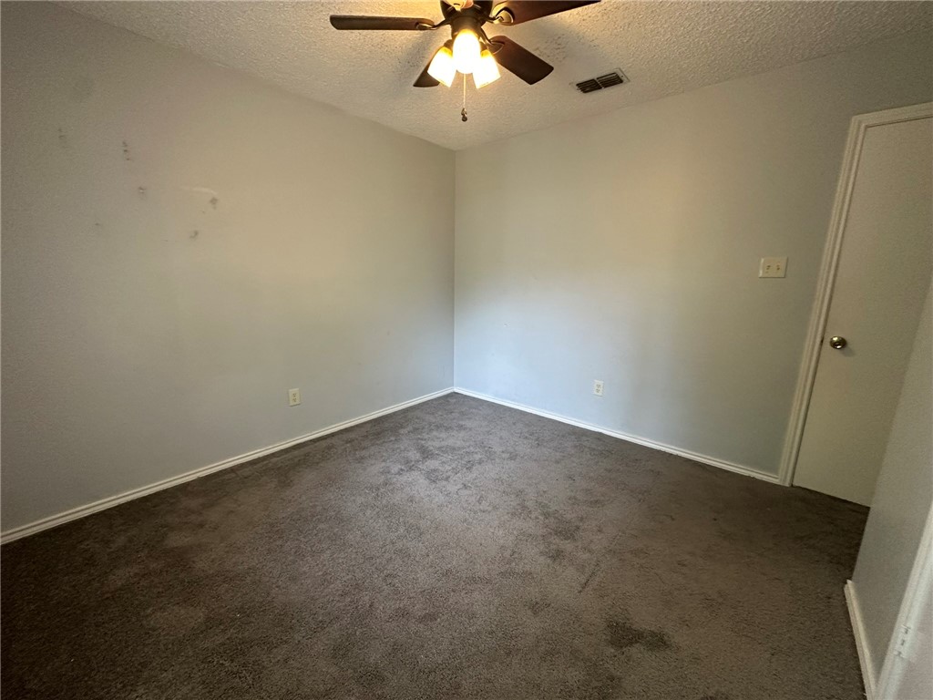 2189 Spring Park Drive Ingleside, TX 78362 - Photo 28 of 35 an empty room with a ceiling fan and carpet