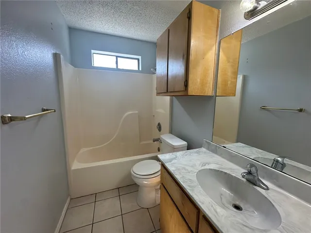 a bathroom with a sink toilet and mirror