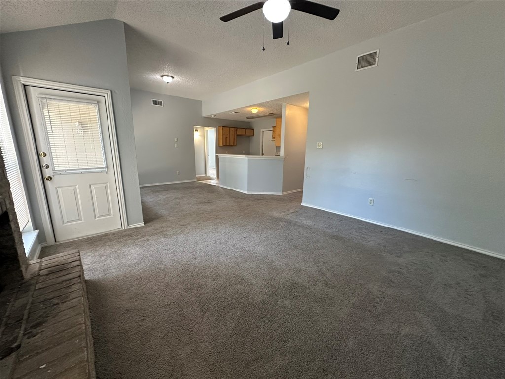 2189 Spring Park Drive Ingleside, TX 78362 - Photo 4 of 35 an empty room with chandelier fan and windows