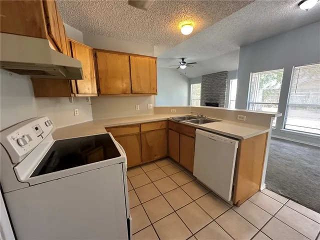a kitchen that has a sink and a stove in it
