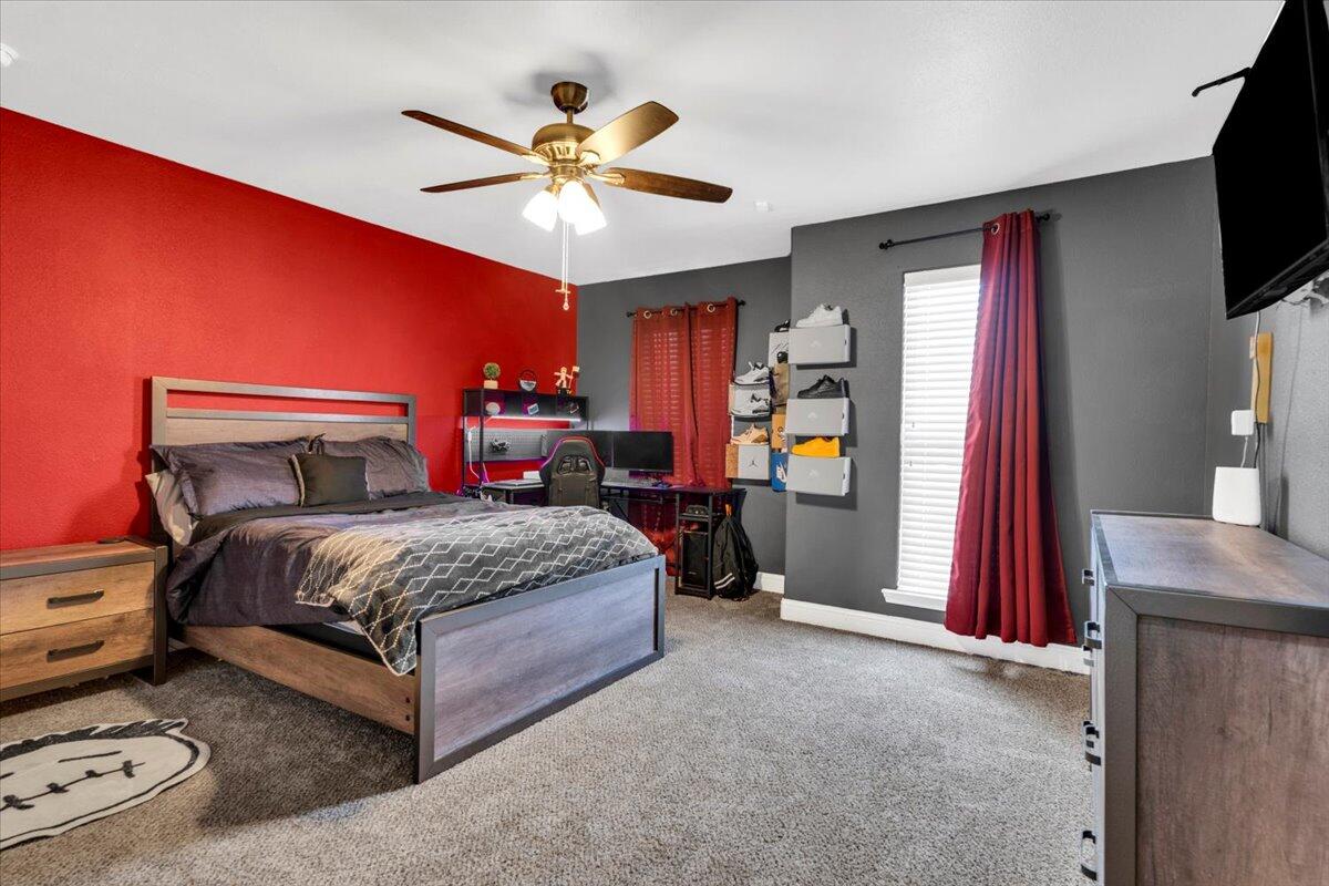 3641 Ridgely Avenue Lubbock, TX 79407 - Photo 17 of 32 a bedroom with a bed and a flat screen tv