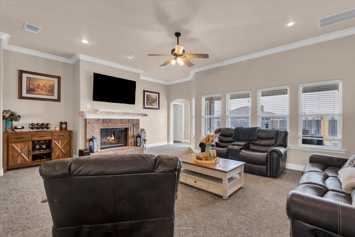 3641 Ridgely Avenue Lubbock, TX 79407 - Photo 5 of 32 a living room with furniture fireplace and a flat screen tv