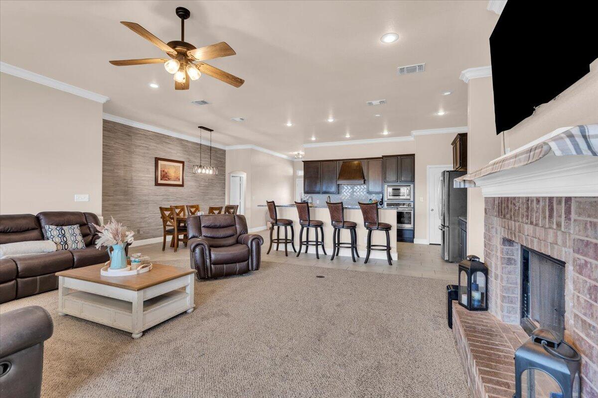3641 Ridgely Avenue Lubbock, TX 79407 - Photo 7 of 32 a living room with furniture and a fireplace