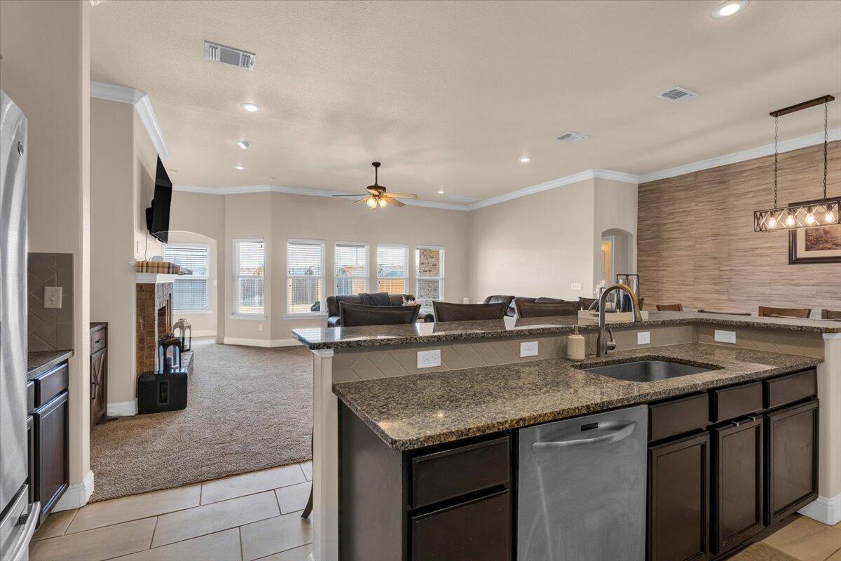 3641 Ridgely Avenue Lubbock, TX 79407 - Photo 10 of 32 a kitchen with stainless steel appliances granite countertop a sink a oven a counter space and cabinets