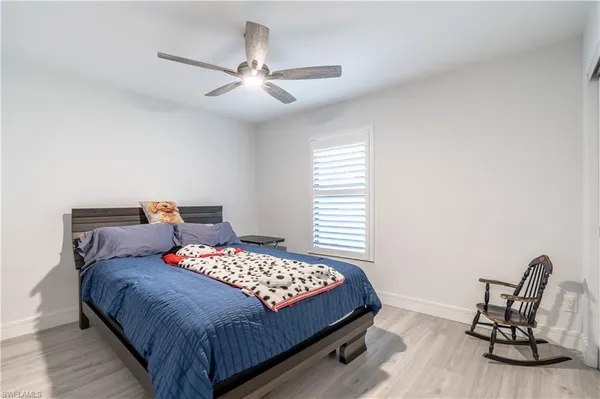 a bedroom with a bed chair and window