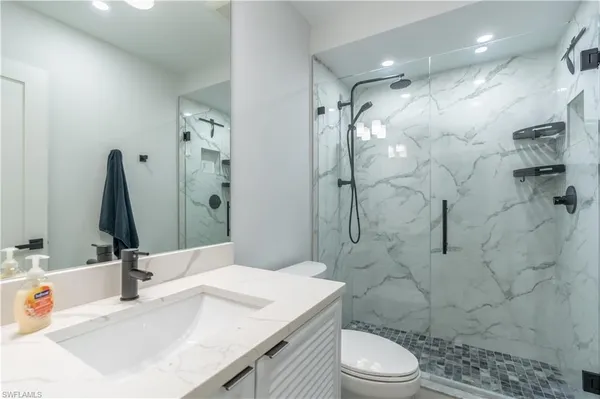 a bathroom with a sink toilet and shower