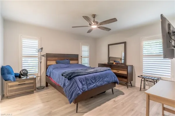 a bedroom with a bed and wooden floor