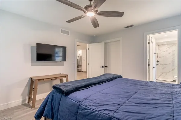 a bedroom with a bed and a flat screen tv
