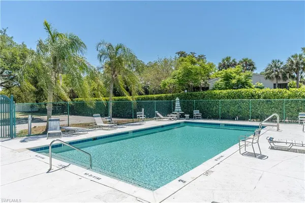 a view of a swimming pool with a table and chairs