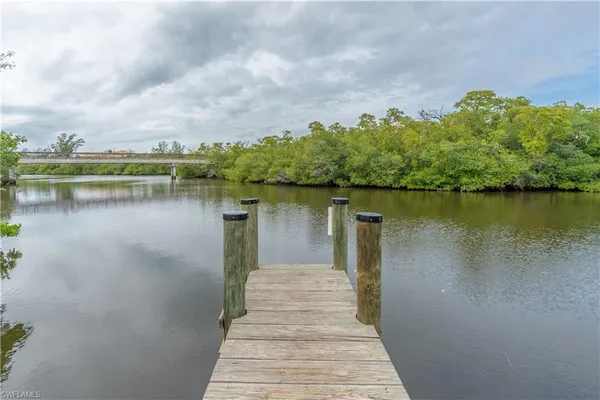 a view of a lake with houses in the back