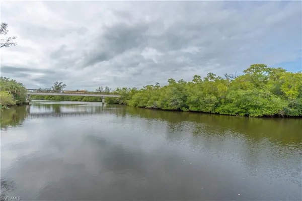 a view of a lake with houses in the back
