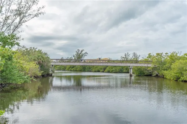 a view of a lake with houses in the back