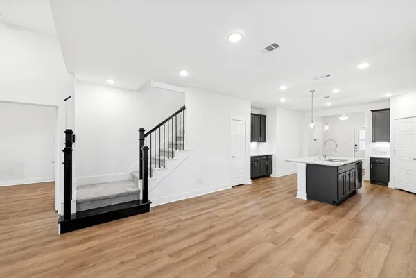 a view of a kitchen with cabinets and wooden floor