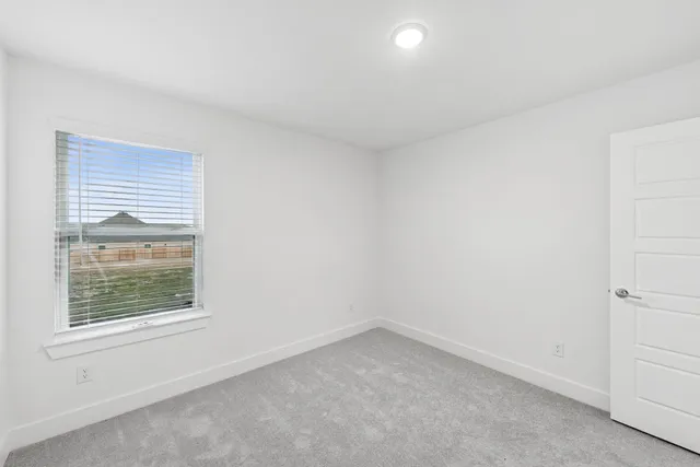 a bathroom with double vanity sinks a toilet a mirror and shower