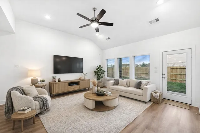 a living room with furniture and a flat screen tv