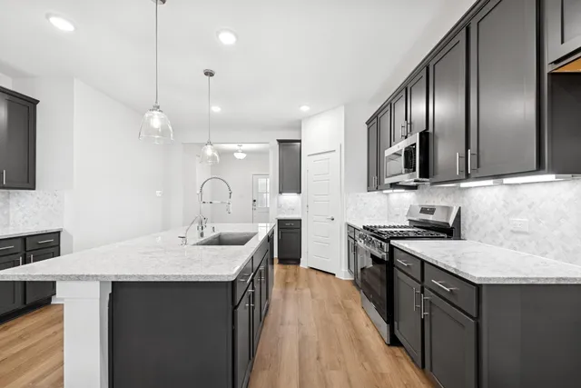 a kitchen with a sink stove and cabinets