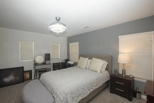 a bedroom with a bed and a chandelier