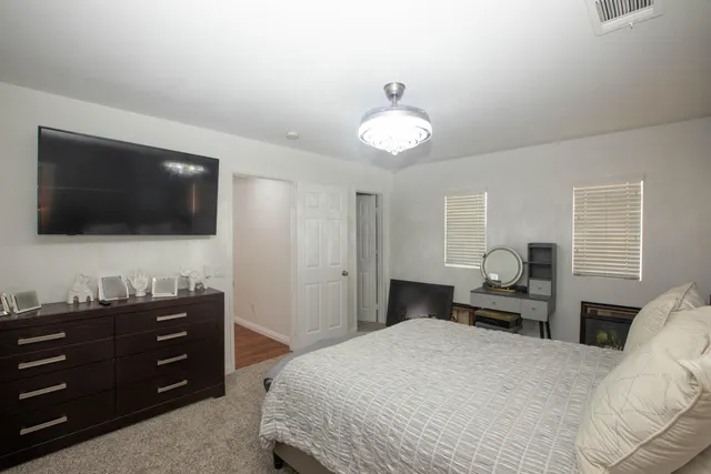 a bedroom with a bed and a flat screen tv