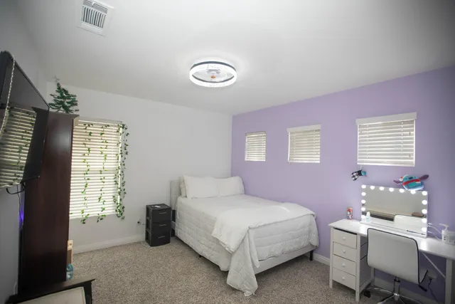 a bedroom with a bed and a window