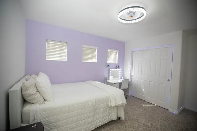 a bedroom with a bed and a chandelier