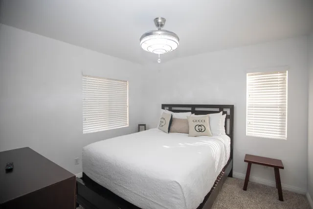 a bedroom with a bed and a chandelier