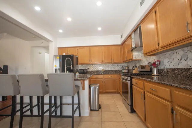 a kitchen with stainless steel appliances granite countertop a sink and cabinets