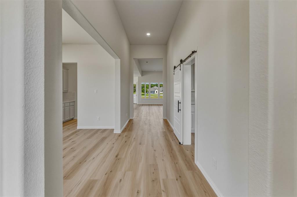 605 Tay Tay Way Springtown, TX 76082 - Photo 5 of 31 Long hallway featuring wood-finish flooring and recessed lighting