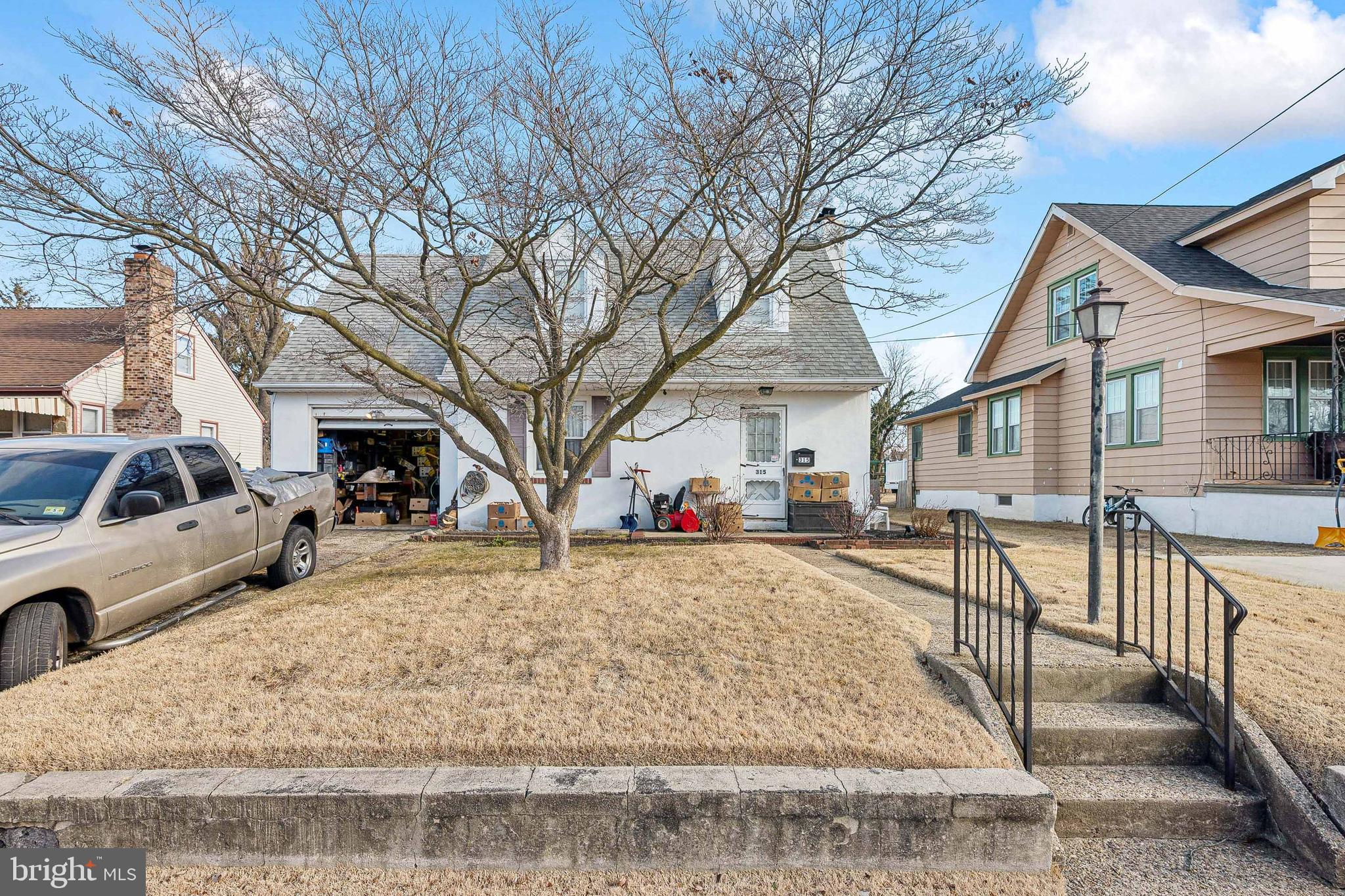 a view of a white house with a yard covered in snow