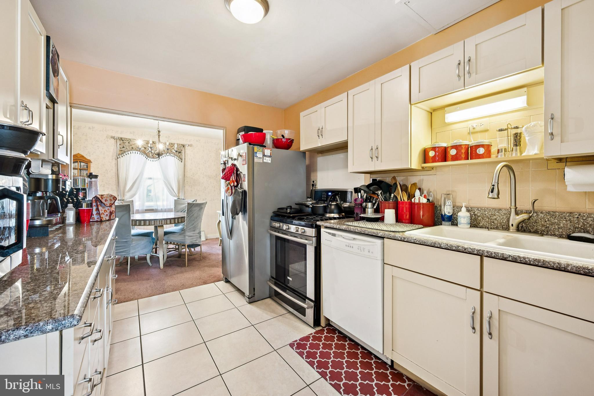 315 Rancocas Avenue Riverside, NJ 08075 - Photo 12 of 24 a kitchen with a sink a refrigerator and cabinets