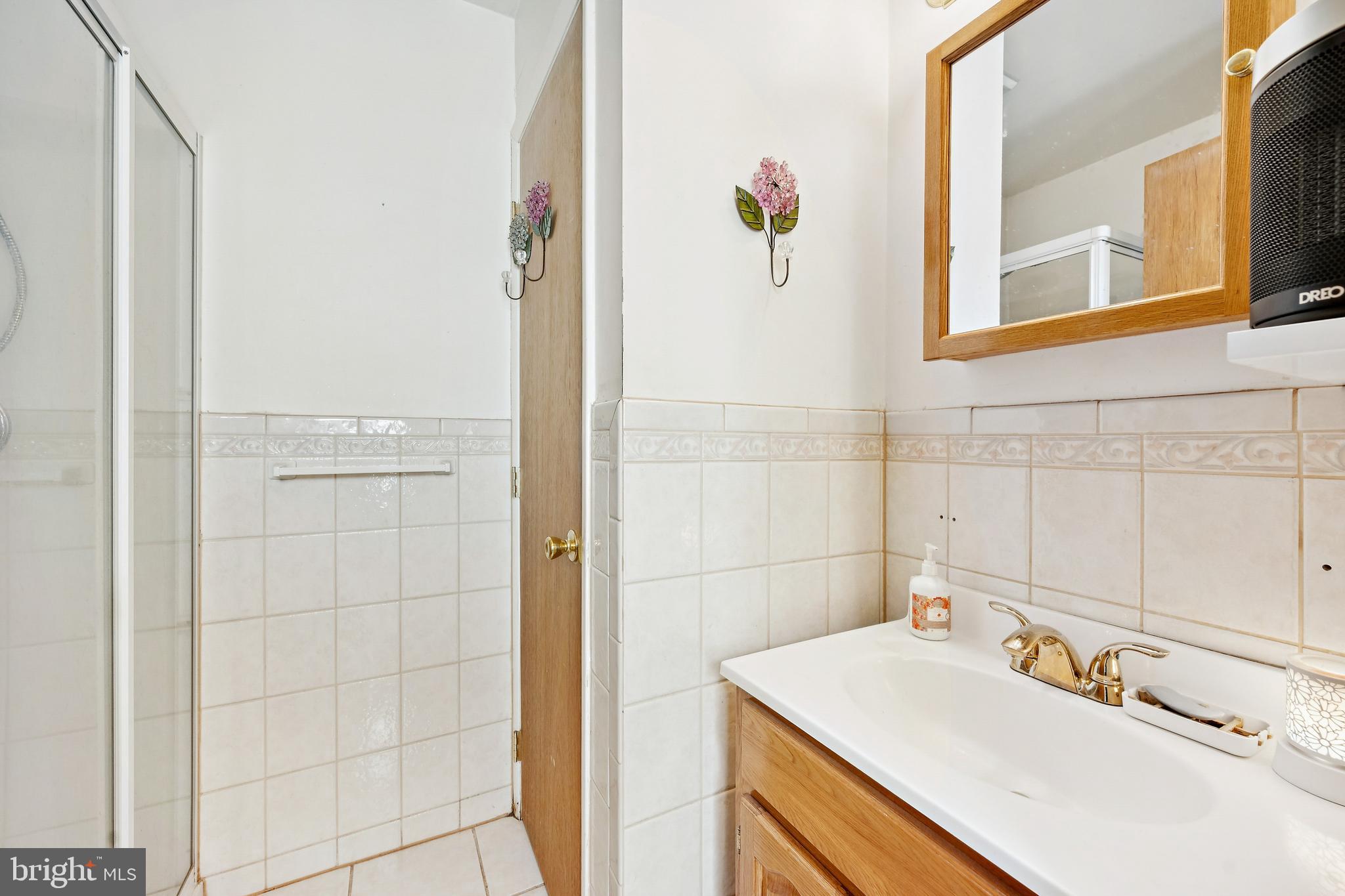 315 Rancocas Avenue Riverside, NJ 08075 - Photo 24 of 24 a bathroom with a sink vanity and a mirror