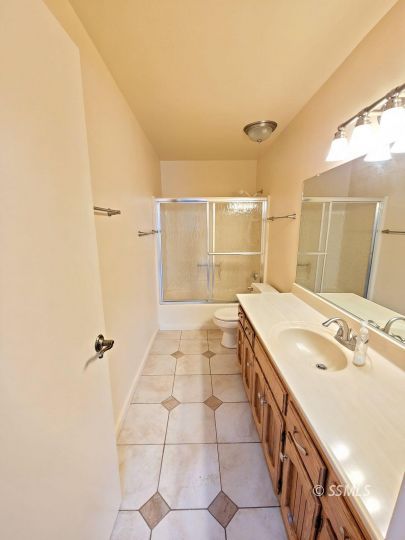 616 South Appaloosa Street Ridgecrest, CA 93555 - Photo 11 of 18 a spacious bathroom with a granite countertop sink a mirror and a