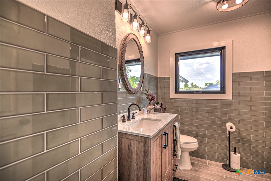 2810 FM 438 Loop Temple, TX 76501 - Photo 15 of 47 a bathroom with a toilet sink vanity and mirror